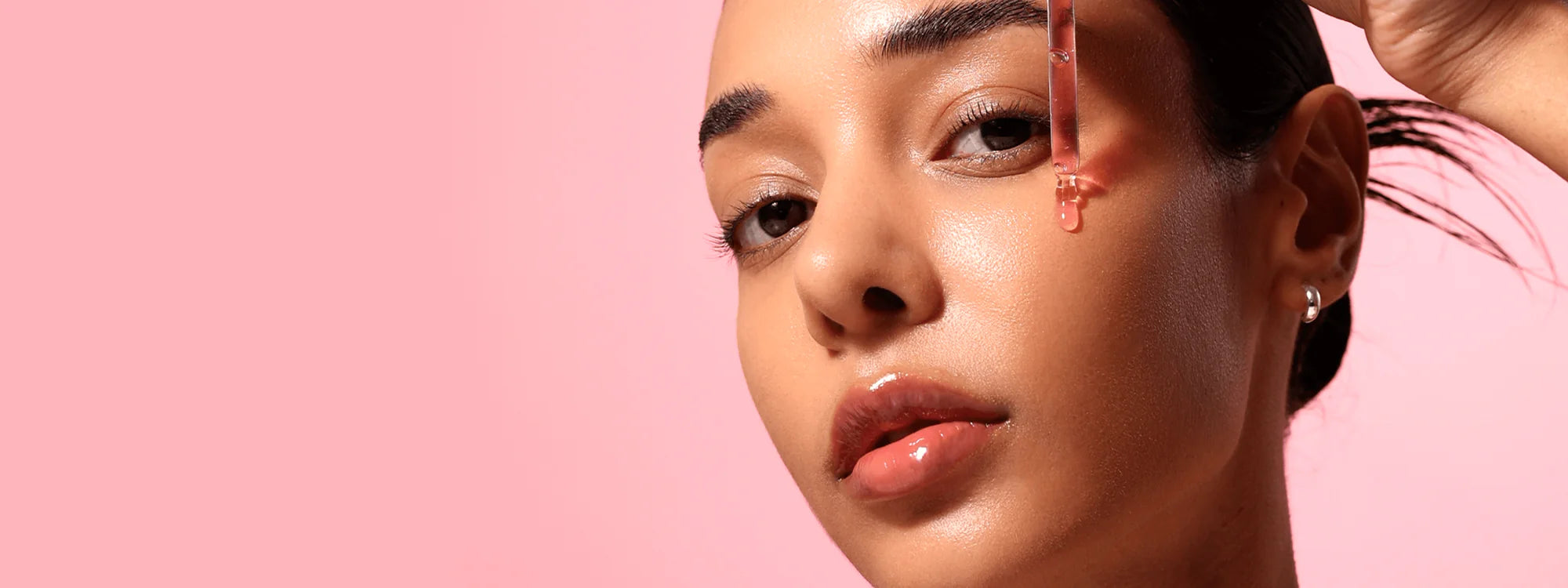 Anua's image; close-up of a person with a pink background