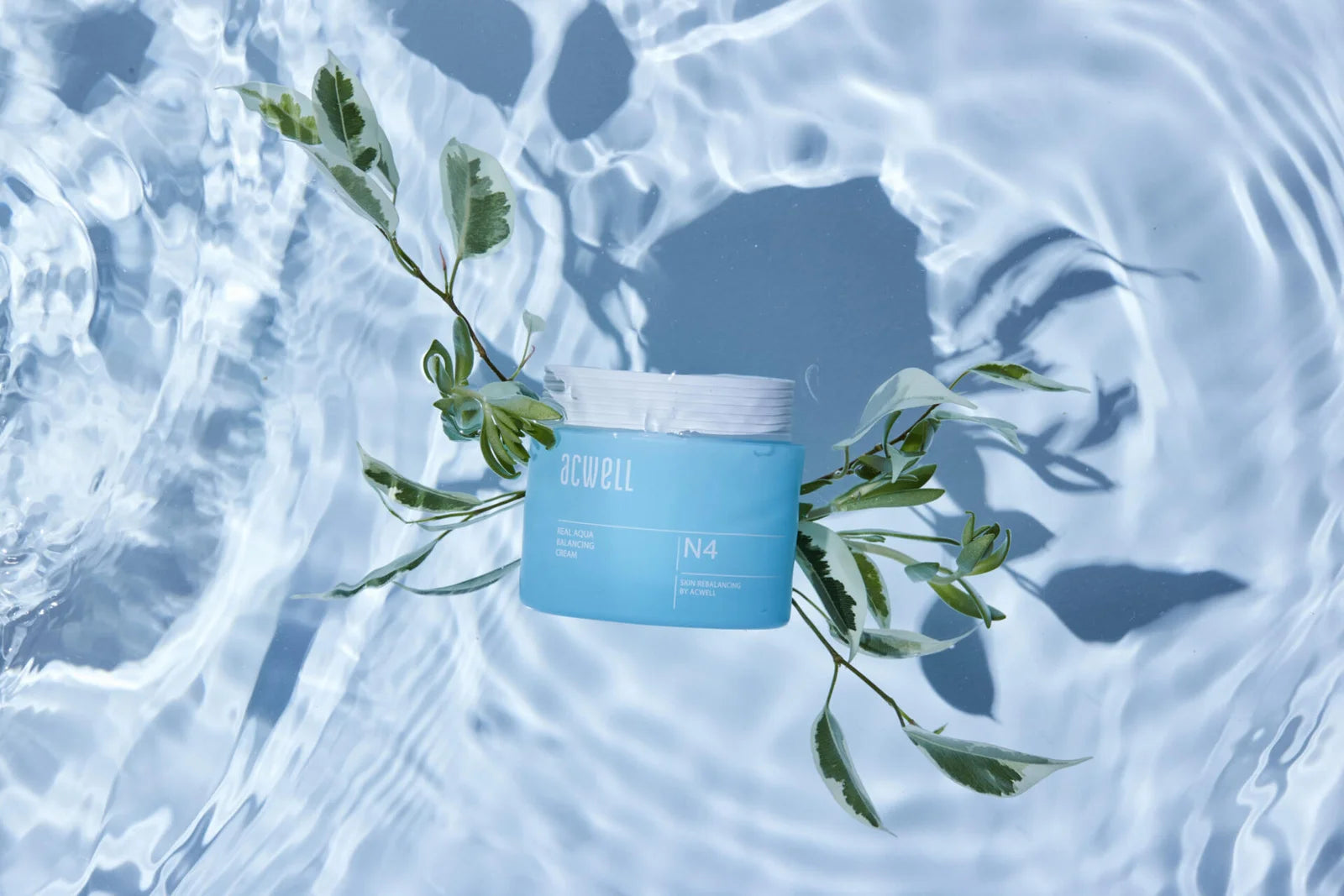 Acwell's blue jar with a plant on a water surface